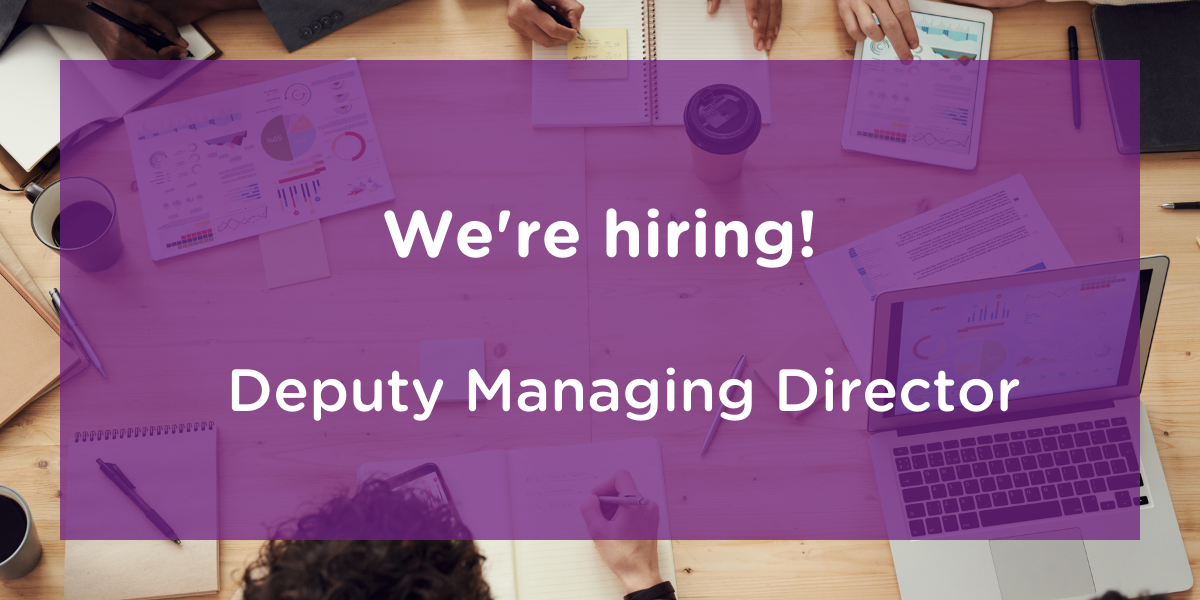 We're hiring! Deputy Managing Director on transparent purple background over images of people sitting at a table with notebooks and laptops